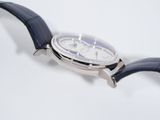 a close up of a watch on a white surface