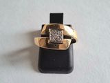 an image of a gold ring with a diamond on it