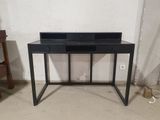 an image of a black desk with a drawer on top of it