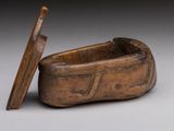 an old wooden box with a wooden lid sitting on a table
