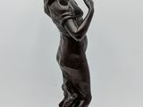 an antique bronze statue of a woman holding a bird in her hand