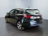 a picture of a black car parked in a showroom