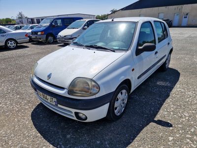a small white car parked in a parking lot