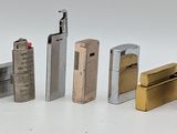 several lighters are lined up in a row on a white surface