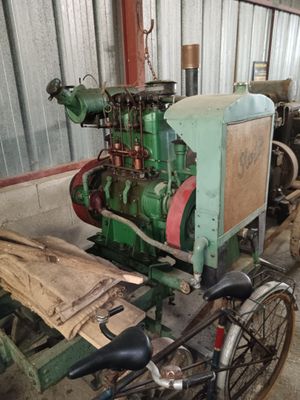 a bike that is parked next to an old engine