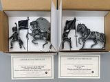 two boxes that have figurines of horses in them