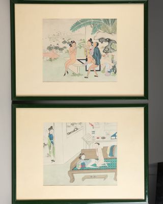 two framed pictures on the wall of a living room