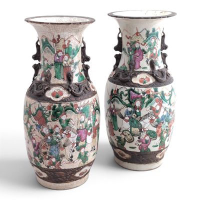 pair of chinese vases with floral designs on them against a white background