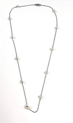 un gros plan d'un collier composé de perles montées sur une chaîne