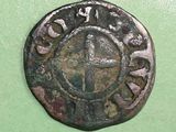 a close up of an old coin on a green surface