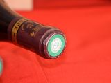 a bottle of wine sitting on a red table cloth
