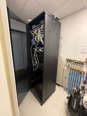 an image of a server in a room with a lot of wires in it