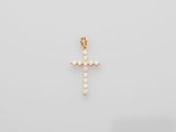a diamond cross pendant on a white background