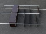 an overhead view of a table and bench in a parking lot