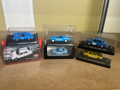 four different models of cars in plastic cases on a counter