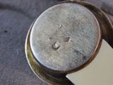a close up of a watch with a white band