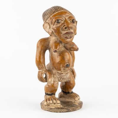 an image of a wooden statue of a man with a hat on his head