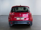 the rear end of a red car in a white room