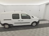 the small white van is parked in a clean garage