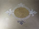 a silver plate with a yellow and white design on it