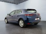 the rear view of a blue car parked in a garage