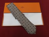 tie in a gift box on a red table cloth