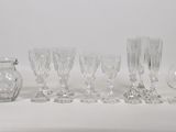 a lot of wine glasses and a pitcher on the table