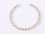 a close up of a bracelet with pearls on a white surface