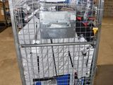 a metal cart with many items in it in a warehouse