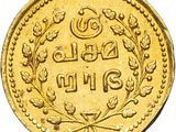 a close up of a gold coin on a white background