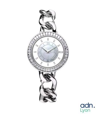 a close up of a woman ' s wrist watch with a chain around it