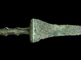 an image of a very old looking knife on a black background