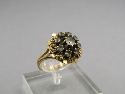 a close up of a gold ring with a black diamond on it