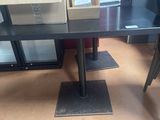 a black table with a glass top and a black chair
