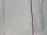 a close up of a white towel with a red line on it