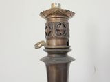 a metal lamp that is on top of a table