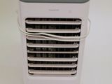 a small air conditioner sitting on top of a white table
