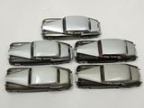four silver cars are lined up on a white surface