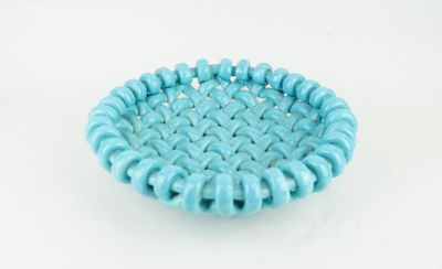 a close up of a small blue bowl on a white surface