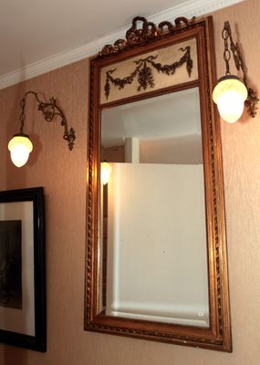 un miroir accroché au mur au-dessus d'un lavabo et un miroir accroché au mur