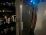 an image of a refrigerator in a room with a lot of bottles