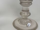 a clear glass candle holder with a tag on it