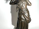 statue of a woman with a horse ' s head in her hands
