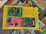a lot of comic books that are on the table