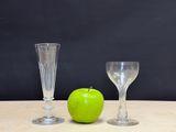 two empty wine glasses and an apple on the table
