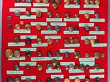 a red bulletin board with a bunch of coins on it