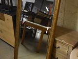 a mirror that is sitting on the floor next to a table