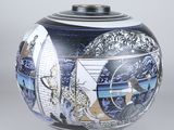 a blue and white vase with a painting on it