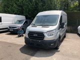 a white van parked in a parking lot next to a white van