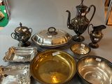 a table with a lot of silver and silverware on it